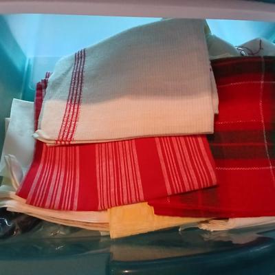A three-drawer Sterilite cart filled with a festive variety of seasonal table linens and fabric decor