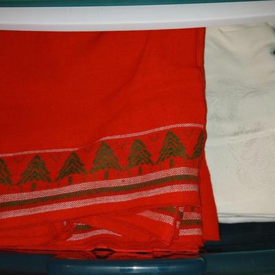A three-drawer Sterilite cart filled with a festive variety of seasonal table linens and fabric decor