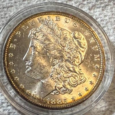 1885-O UNCIRCULATED CONDITION MORGAN SILVER DOLLAR AS PICTURED. (COIN #1742).