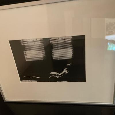 Black and white framed decor with red vas