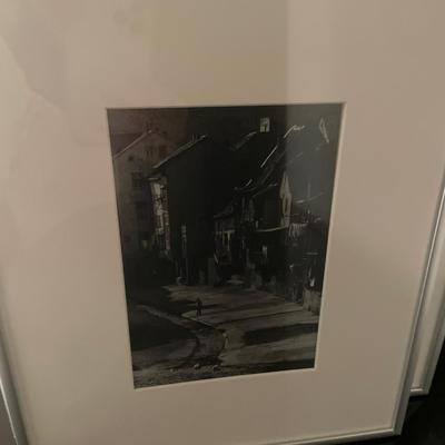 Black and white framed decor with red vas