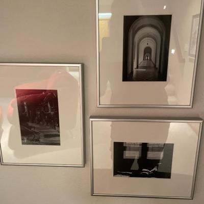 Black and white framed decor with red vas