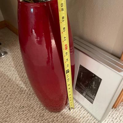 Black and white framed decor with red vas