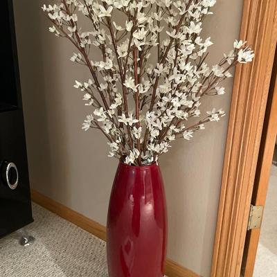 Black and white framed decor with red vas