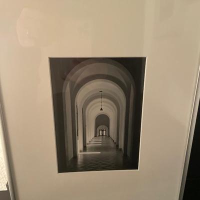 Black and white framed decor with red vas