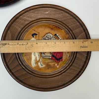 Sale Photo Thumbnail #507: Set of 3 plates showing traditional Basque costumed dancers and villagers.  Round wooden plates framing painted, embossed leather works of art. Plates are approx. 9.5" across.  Very good condition.