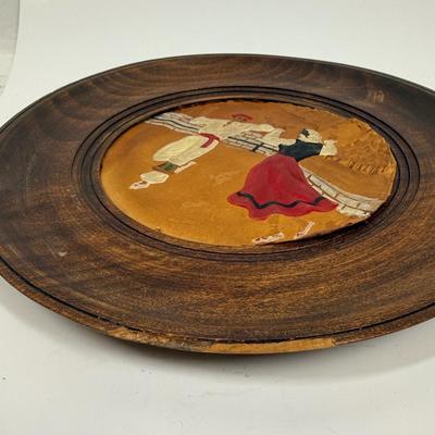 Sale Photo Thumbnail #508: Set of 3 plates showing traditional Basque costumed dancers and villagers.  Round wooden plates framing painted, embossed leather works of art. Plates are approx. 9.5" across.  Very good condition.