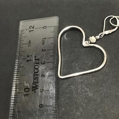 Silver toned heart dangle earrings
