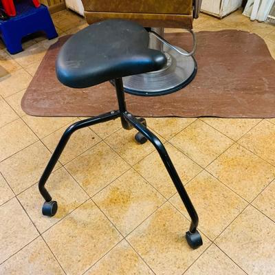 LOT 86: Mid - Century Adjustable Barber’s Chair with Barber Capes and a Three Leg Roll About Stool