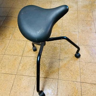 LOT 86: Mid - Century Adjustable Barber’s Chair with Barber Capes and a Three Leg Roll About Stool