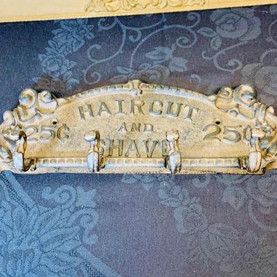 LOT 91: Barber Shop Memorabilia a Framed Etching, Cast Iron Haircut Plaque, Wooden Barber Poll, Books and Mor