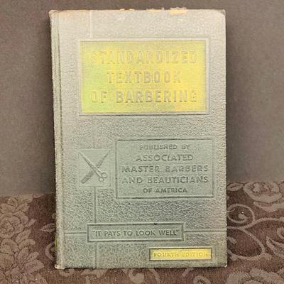 LOT 91: Barber Shop Memorabilia a Framed Etching, Cast Iron Haircut Plaque, Wooden Barber Poll, Books and Mor