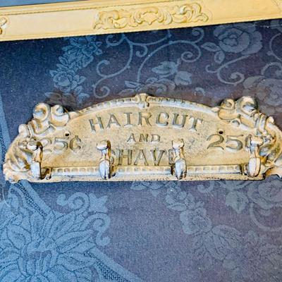 LOT 91: Barber Shop Memorabilia a Framed Etching, Cast Iron Haircut Plaque, Wooden Barber Poll, Books and Mor