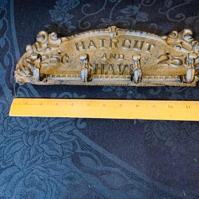LOT 91: Barber Shop Memorabilia a Framed Etching, Cast Iron Haircut Plaque, Wooden Barber Poll, Books and Mor