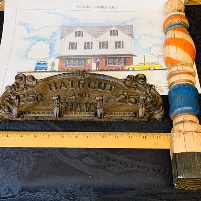 LOT 91: Barber Shop Memorabilia a Framed Etching, Cast Iron Haircut Plaque, Wooden Barber Poll, Books and Mor