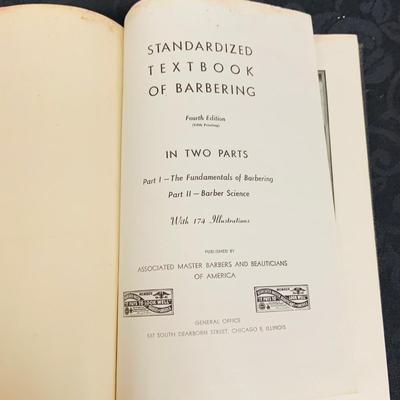 LOT 91: Barber Shop Memorabilia a Framed Etching, Cast Iron Haircut Plaque, Wooden Barber Poll, Books and Mor