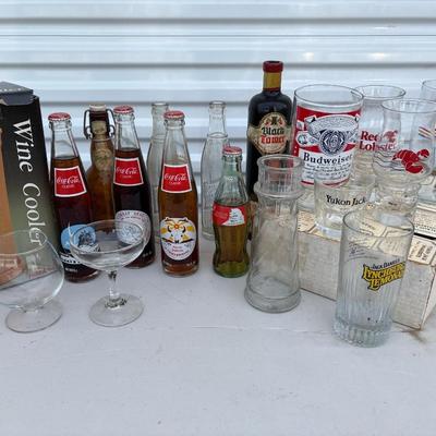 Bar, glassware and vintage Coca-Cola and other bottles