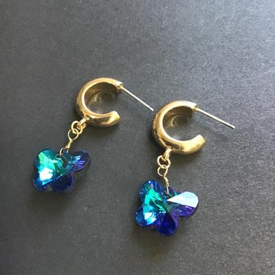 Gold tone hoop earrings with butterfly crystal charms