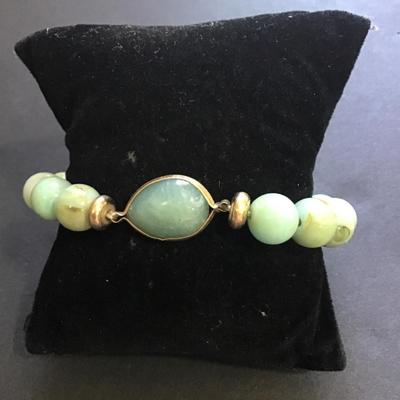 Teal colored beaded stretch bracelet with faux stone