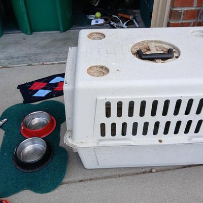 Dog carrier with an assortment of dog supplies - Bowls- clothes - leashed and more