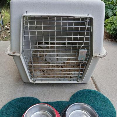 Dog carrier with an assortment of dog supplies - Bowls- clothes - leashed and more