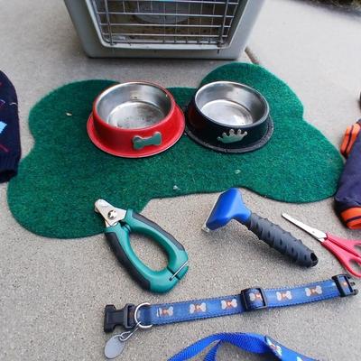 Dog carrier with an assortment of dog supplies - Bowls- clothes - leashed and more