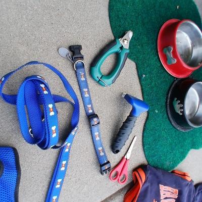 Dog carrier with an assortment of dog supplies - Bowls- clothes - leashed and more