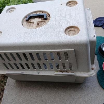 Dog carrier with an assortment of dog supplies - Bowls- clothes - leashed and more