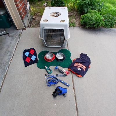 Dog carrier with an assortment of dog supplies - Bowls- clothes - leashed and more