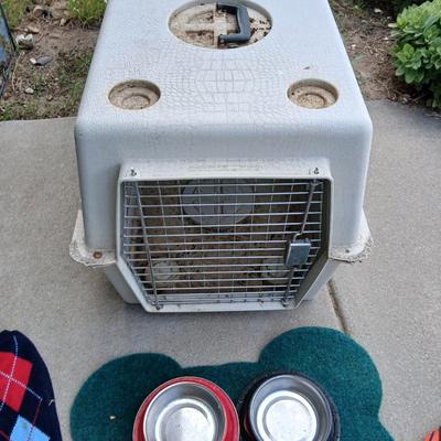 Dog carrier with an assortment of dog supplies - Bowls- clothes - leashed and more