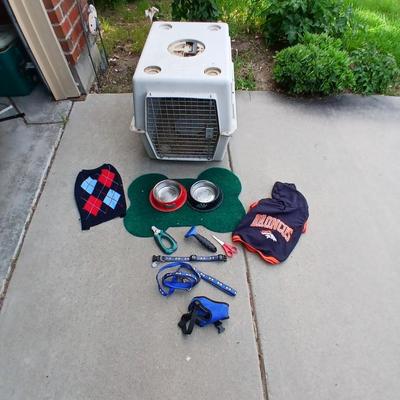 Dog carrier with an assortment of dog supplies - Bowls- clothes - leashed and more