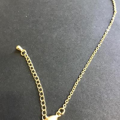 Gold toned necklace with purple crystal
