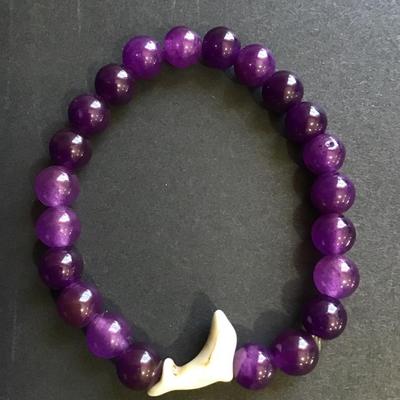 Purple beaded stretch bracelet with dolphin charm