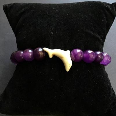 Purple beaded stretch bracelet with dolphin charm