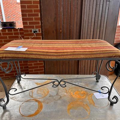 Cushion topped iron bench