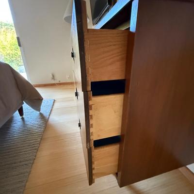 Sale Photo Thumbnail #6: The Stanley dresser is a mid-century modern piece designed for the bedroom. It features a medium wood tone with a walnut finish and chrome handles. Measuring 64 inches in length, 18 inches in width, and 30.5 inches in height, it offers nine drawers for am