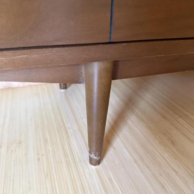 Sale Photo Thumbnail #7: The Stanley dresser is a mid-century modern piece designed for the bedroom. It features a medium wood tone with a walnut finish and chrome handles. Measuring 64 inches in length, 18 inches in width, and 30.5 inches in height, it offers nine drawers for am