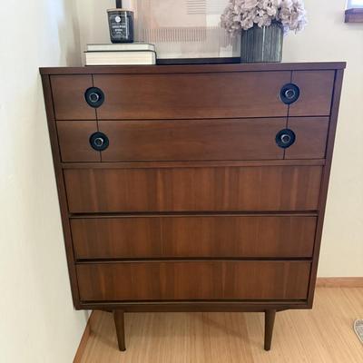 Sale Photo Thumbnail #9: This Stanley dresser is a mid-century modern piece crafted from solid walnut wood, featuring a dark wood tone. It has a rectangular shape with dimensions of 36 inches in width, 18 inches in depth, and 44.5 inches in height. The dresser includes five drawe