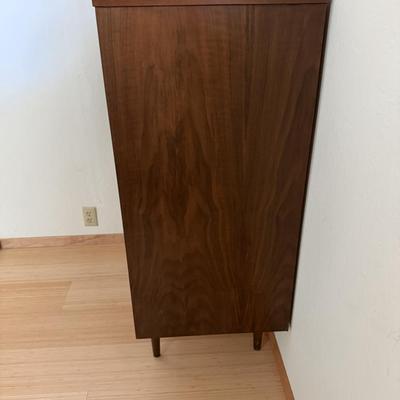 Sale Photo Thumbnail #11: This Stanley dresser is a mid-century modern piece crafted from solid walnut wood, featuring a dark wood tone. It has a rectangular shape with dimensions of 36 inches in width, 18 inches in depth, and 44.5 inches in height. The dresser includes five drawe