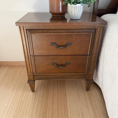 Sale Photo Thumbnail #20: This classic cherry nightstand is a stylish addition to any bedroom. Measuring 22 inches in width, 15 inches in depth, and 24.5 inches in height, it features two drawers for convenient storage. Made from wood with a dark wood tone finish, it requires no a