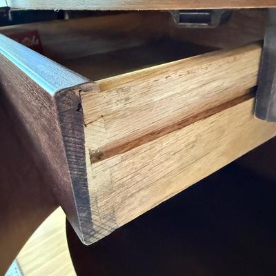 Sale Photo Thumbnail #26: This Kent Coffey nightstand from the Perspecta line is a mid-century modern piece crafted from walnut, featuring a medium wood tone and a single drawer for storage. Measuring 25 inches in height, 25 inches in width, and 17 inches in length, it is fully as