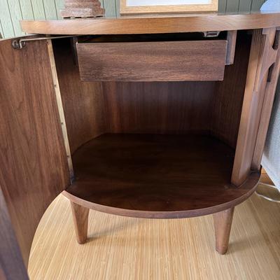 Sale Photo Thumbnail #25: This Kent Coffey nightstand from the Perspecta line is a mid-century modern piece crafted from walnut, featuring a medium wood tone and a single drawer for storage. Measuring 25 inches in height, 25 inches in width, and 17 inches in length, it is fully as