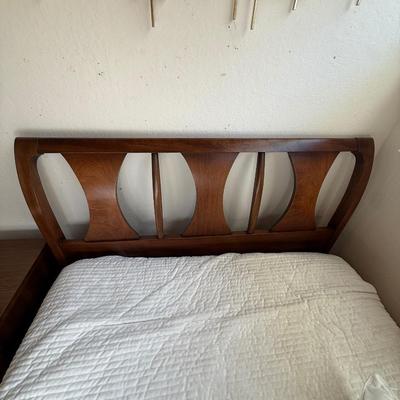 Sale Photo Thumbnail #30: This Kent Coffey headboard is a full-size piece crafted from walnut and rosewood, showcasing a Mid Century Modern style with elegant curved detailing. It is an original piece from the mid-20th century, designed for adults. The headboard features an authen