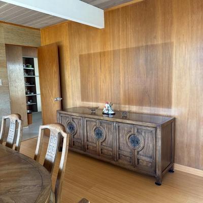 Sale Photo Thumbnail #32: The Nadeau credenza is a mid-century modern piece crafted from walnut, featuring a rich walnut finish. It measures 30 inches in height, 76.5 inches in length, and 19 inches in width. This rectangular, free-standing unit includes two doors with raised pane