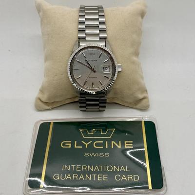 Sale Photo Thumbnail #213: Nice working condition, Jubilee Style Band. Running, tested to confirm time and date can be adjusted and set. Nice Cherrywood box. From 2002.