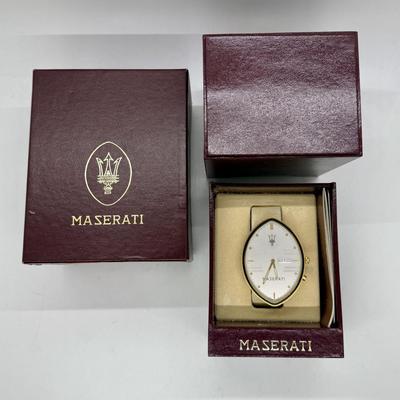 Sale Photo Thumbnail #246: Quartz movement, silvered dial, gilt luminous numeral dots. comes with Maserati boxes (see photos).
Case: gold plated, black lined bezel, vintage dash clock shape, screw secured back, 56 mm x 40 mm, glass crystal
Condition: Looks great, no scratches on cr