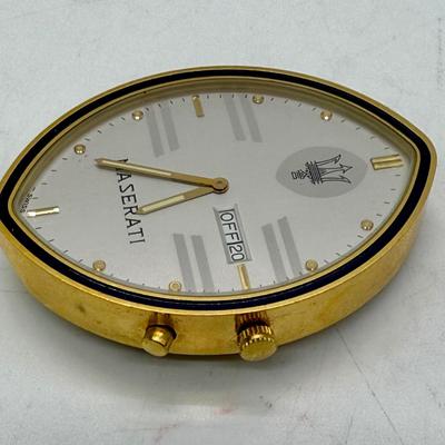 Sale Photo Thumbnail #243: Quartz movement, silvered dial, gilt luminous numeral dots. comes with Maserati boxes (see photos).
Case: gold plated, black lined bezel, vintage dash clock shape, screw secured back, 56 mm x 40 mm, glass crystal
Condition: Looks great, no scratches on cr