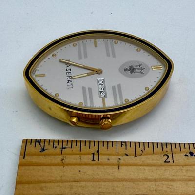 Sale Photo Thumbnail #244: Quartz movement, silvered dial, gilt luminous numeral dots. comes with Maserati boxes (see photos).
Case: gold plated, black lined bezel, vintage dash clock shape, screw secured back, 56 mm x 40 mm, glass crystal
Condition: Looks great, no scratches on cr