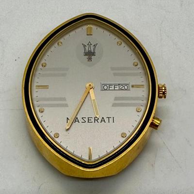 Sale Photo Thumbnail #242: Quartz movement, silvered dial, gilt luminous numeral dots. comes with Maserati boxes (see photos).
Case: gold plated, black lined bezel, vintage dash clock shape, screw secured back, 56 mm x 40 mm, glass crystal
Condition: Looks great, no scratches on cr