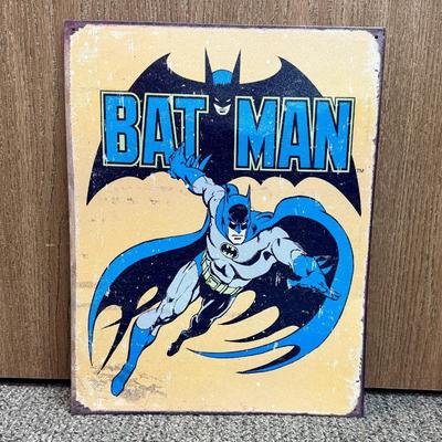 Sale Photo Thumbnail #164: Painted metal sign with an image of the classic 1930’s DC comics Batman. Image is distressed to make it look old.